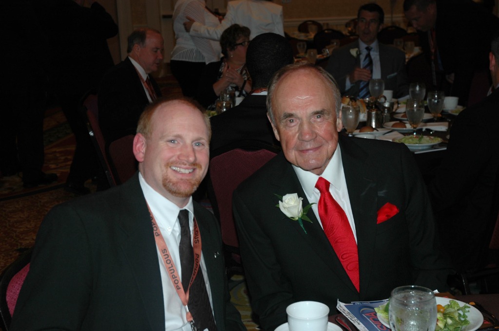 Mark Fleming sitting with Dick Enberg at the 2012 Academic All-America Hall of Fame Induction Ceremony and dinner in St. Louis.